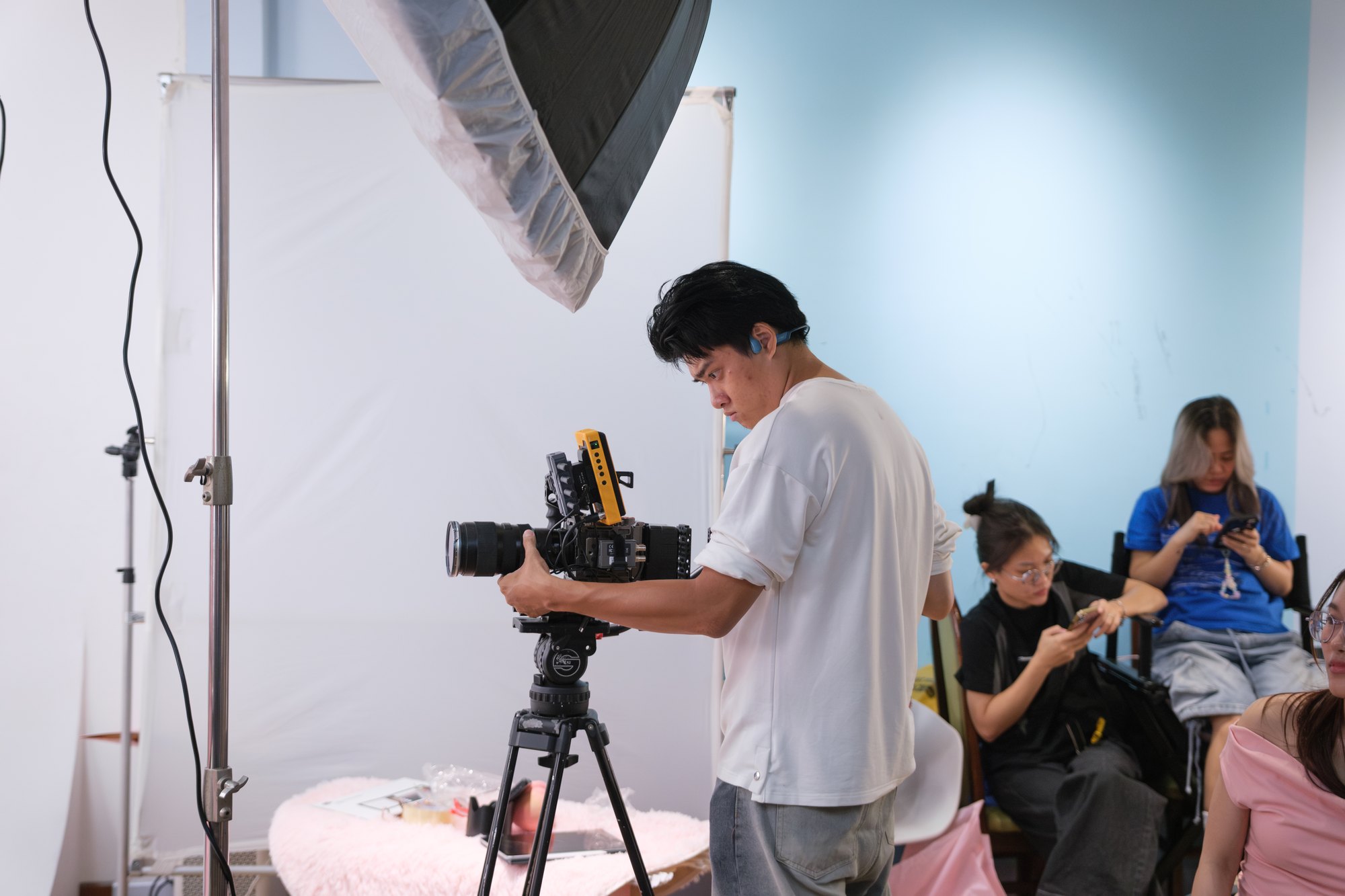 Studio product and portrait setup with softbox and crew