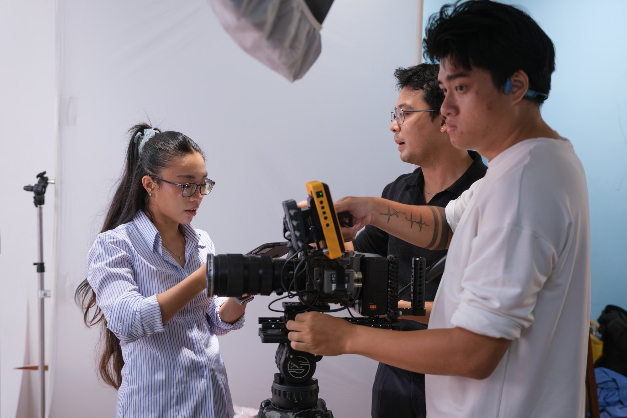 Crew and talent reviewing on the camera at a bright location