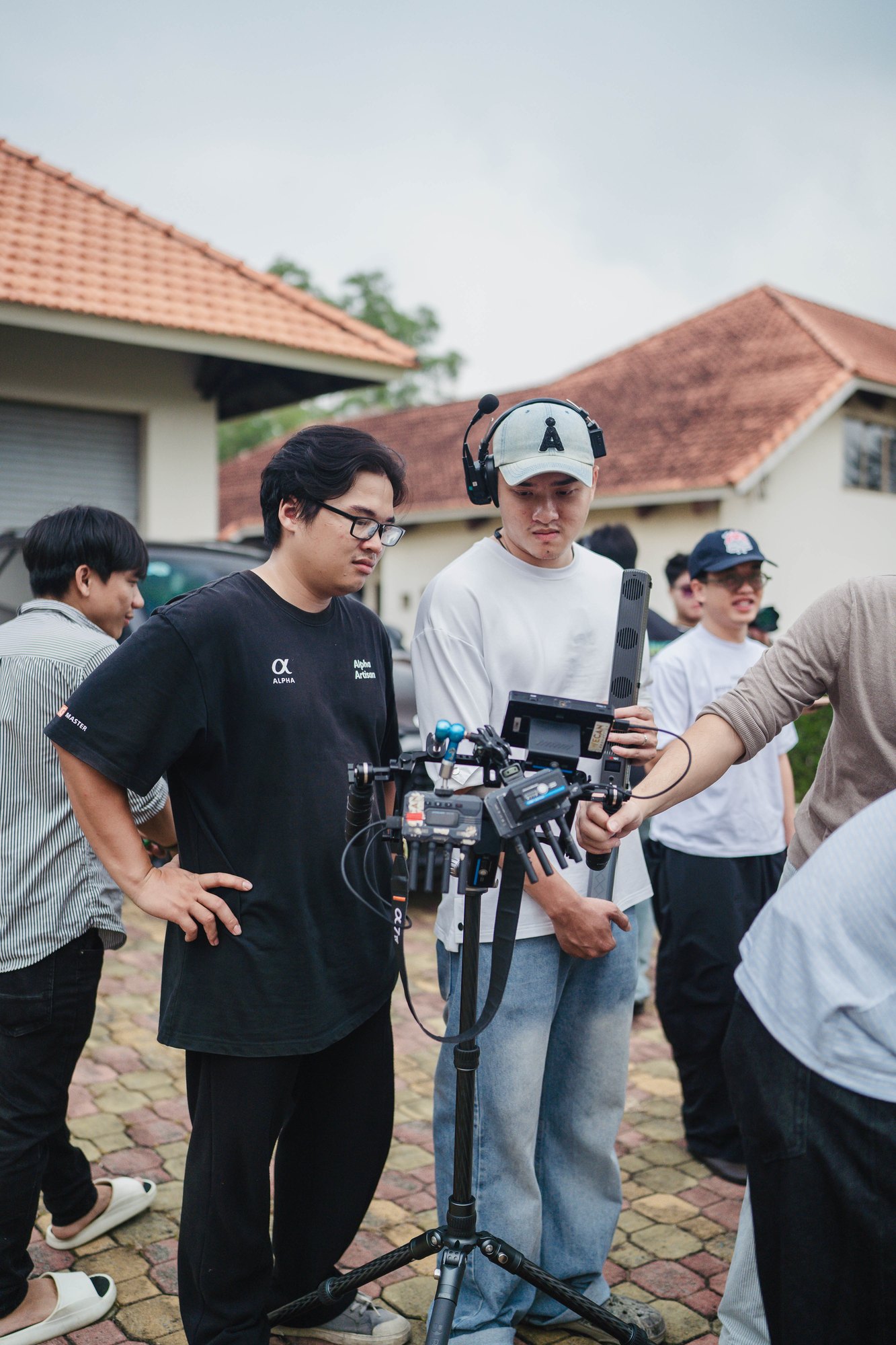 Crew gathered around the camera dolly outdoors